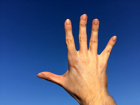 Hand on the Sky Background closeupの写真素材