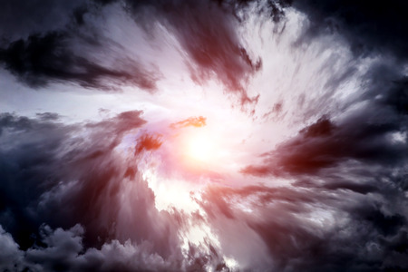 Blurred Swirl in the Dark Storm Clouds with Ray of the Lightの写真素材