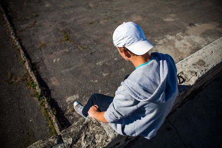 Depressed Teenager sit on the Roof Of Building