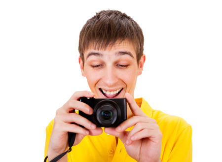 Cheerful Young Man with a Photo Camera Isolated on the White Backgroundの写真素材