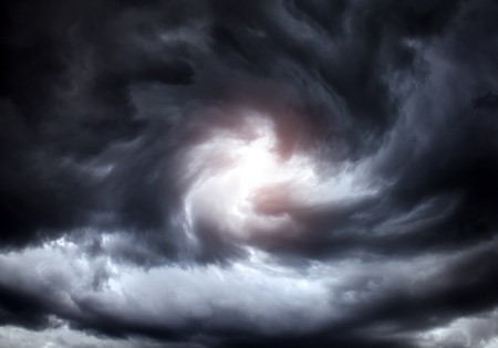 Blurred Swirl in the Dark Storm Clouds with Ray of the Lightの写真素材