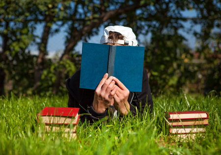 Person with a Books on the Summer Meadowの写真素材