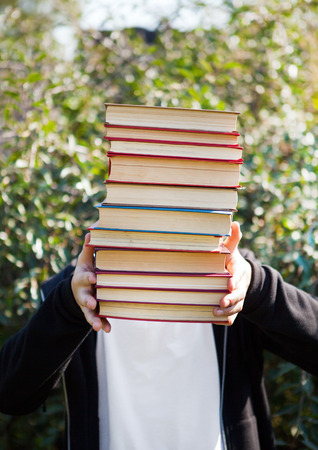 Person with a Books by the Nature Backgroundの写真素材