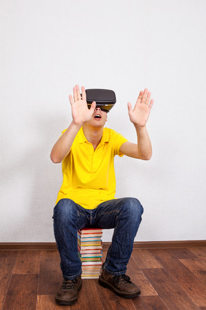 Young Man in Virtual Reality Headset on the Floor with a Booksの写真素材