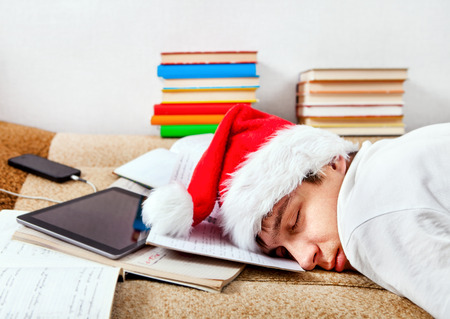 Tired Student in Santa's Hat sleeping on the Couchの写真素材