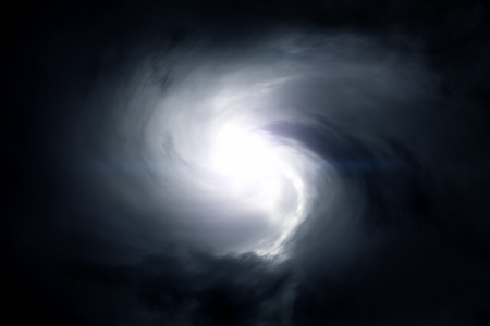 Blurred Swirl in the Dark Storm Clouds with Ray of the Lightの写真素材