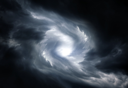 Blurred Swirl in the Dark Storm Clouds with Ray of the Lightの写真素材
