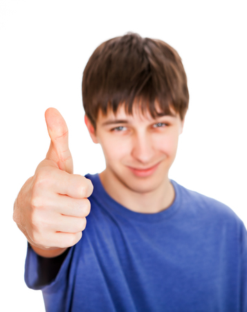 Young Man with Thumb Up on the White Background. Focus on the Handの写真素材