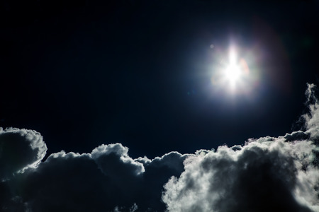 Night Sky with a Light and Dramatic Cloudsの写真素材