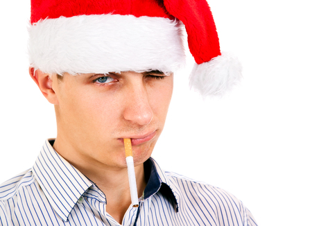 Frown Look Young Man in Santa Hat with Cigarette Isolated on the White Background