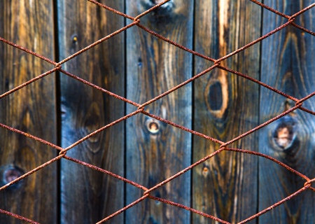 Rusty Wire Netting and Old Wooden Planks Backgroundの写真素材