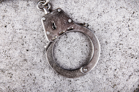 Handcuff on the Grunge Metal Background closeup