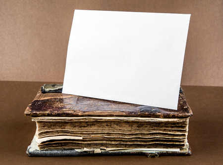 Vintage Book with a Blank Paper on the Brown Background closeupの写真素材