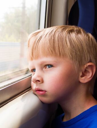 Sad Kid sit in the Train by the Window