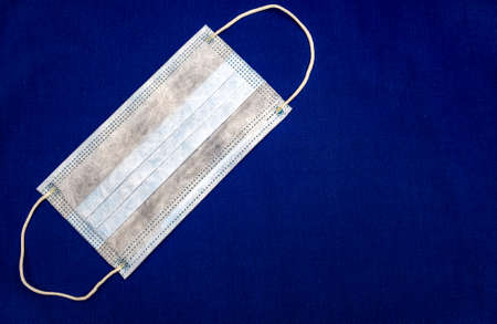 Protective Medical Flu Mask on the Blue Background closeup