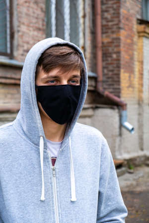 Young Man in the Flu Mask on the Old House Backgroundの写真素材