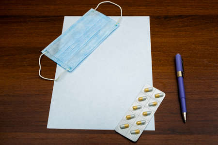 Medical Flu Mask and a Pills on the Empty Paper closeupの写真素材