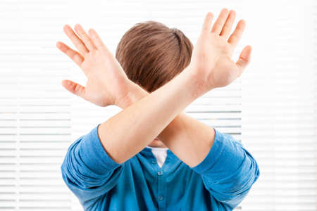 Man show a Refusal Gesture on the Jalousie Background in a Roomの写真素材