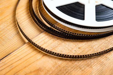 Old Film Reel on the Wooden Planks Background closeupの写真素材