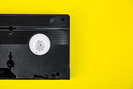 Retro Video Tape Cassette on a Yellow Paper Background