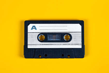 Old Audio Cassettes on the Yellow Paper Background closeupの写真素材