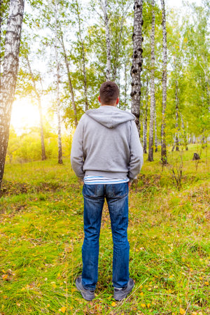 Rear View of a Young Man in the Forest Aloneの写真素材