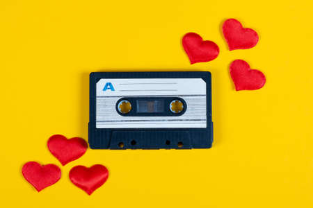 Old Audio Cassette with a Red Hearts on the Yellow Paper Background closeupの写真素材