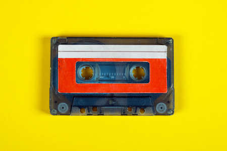 Old Audio Cassettes on the Yellow Paper Background closeup