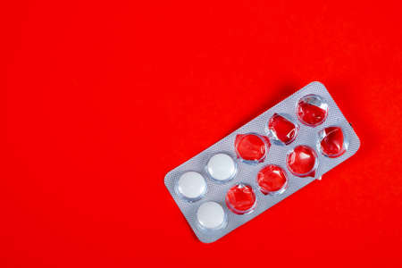 Pills Pack on the Red Paper Background closeupの写真素材