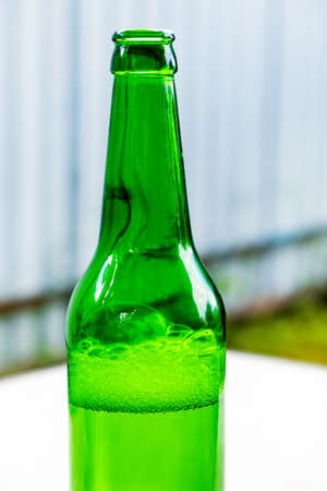Opened Bottle of a Beer on the Street closeupの写真素材