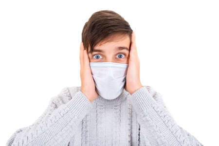 Surprised Young Man in the Flu Mask Isolated on the White Background closeupの写真素材