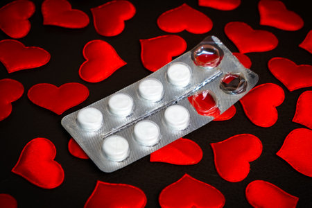 Used Pills Pack on the Scattered Red Hearts Backgroundの写真素材