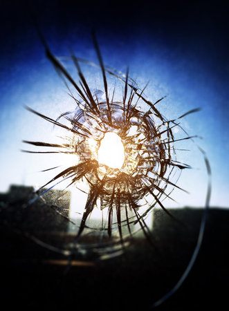 Vignetting Photo of Bullet hole in the Glass closeupの写真素材