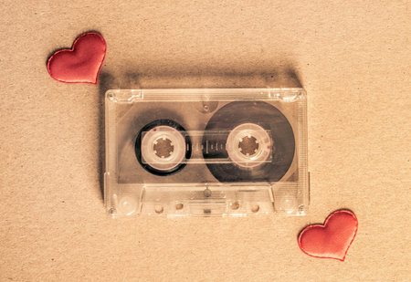 Toned Photo of the Old Audio Tape Cassette with a Red Hearts on the Paper closeupの写真素材