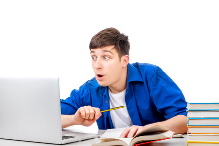 Surprised Student with a Books use a Laptop Computer on the White Backgroundの写真素材