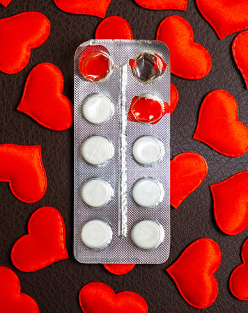 Used Pills Pack on the Scattered Red Hearts Backgroundの写真素材