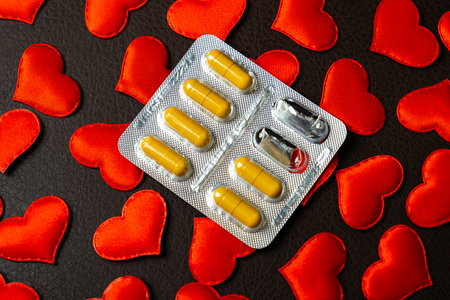 Used Pills Pack on the Scattered Red Hearts Backgroundの写真素材