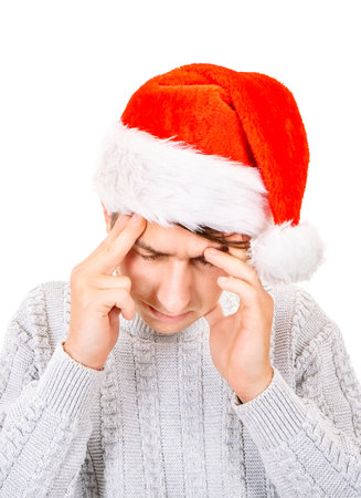 Sad Young Man in Santa Hat feel Headache on The White Background closeupの写真素材