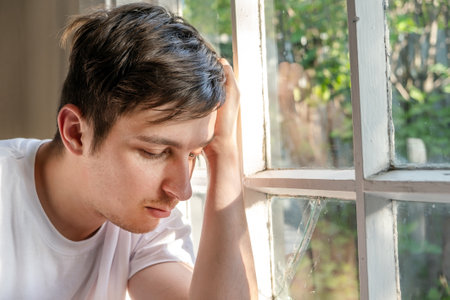 Sorrowful Young Man by the Window in the Room