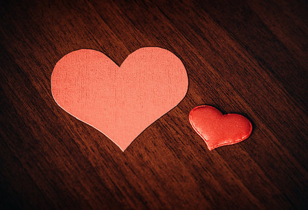 Two Red Hearts Shape on the Wooden Background closeup