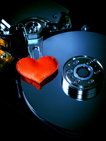 Red Heart Shape on the Opened Hard Disk Drive closeupの写真素材