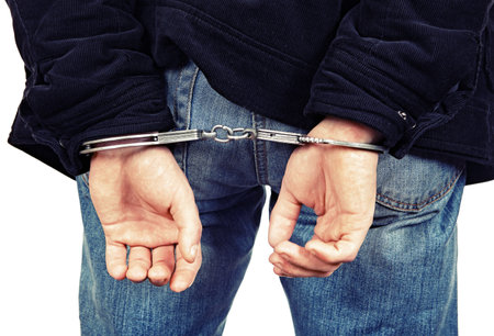 Rear view of the Person in Handcuffs Closeupの写真素材