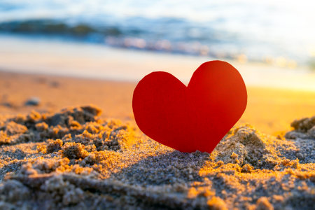 Red Heart in the Sand at the Evening Beachの写真素材