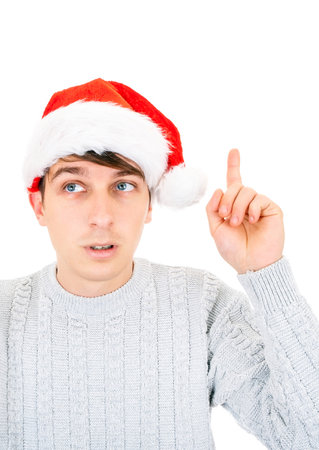 Young Man in Santa Hat with Finger Up Gesture by the White closeupの写真素材