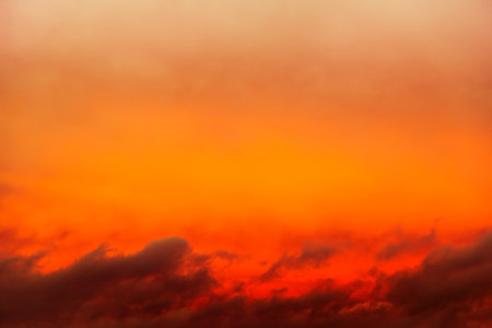 Red Sunlight in the Dark and Dramatic Storm Cloudsの写真素材