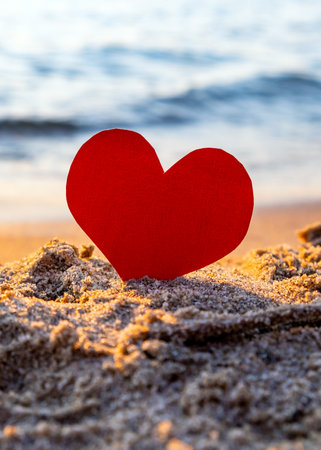 Red Heart in the Sand at the Evening Beachの写真素材