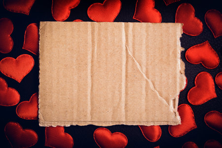 Old Blank Paper on the Scattered Red Hearts Background closeupの写真素材
