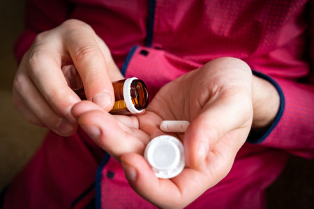 Person take a Pill at the Home Hands closeupの写真素材