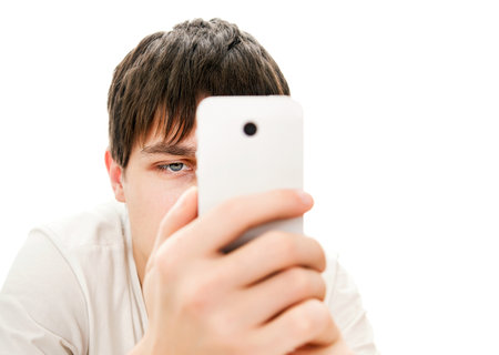 Young Man Take a Photo with a Phone on the White Background closeupの写真素材