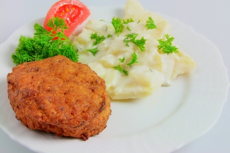 Meat Ball with Potato Salad, Tomato and Parsley on Plateの写真素材